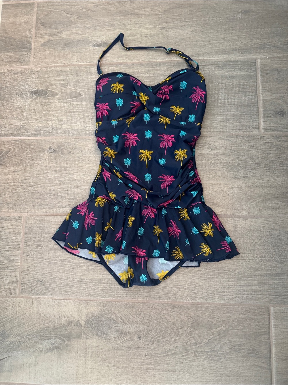 Woman’s Navy Palm Tree One-Piece Swimdress - ruching, which is so slimming.